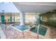 Inviting indoor hot tub area with brick pavers, stainless steel railings, and a decorative mosaic wall at 1501 S Ocean Blvd. S # 1450, Myrtle Beach, SC 29577