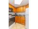 Compact kitchen area featuring wooden cabinets, black countertop, and essential appliances at 1501 S Ocean Blvd. S # 1450, Myrtle Beach, SC 29577