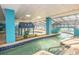 Indoor lazy river featuring tiled accents, a decorative bridge, and ample lounge seating around the perimeter at 1501 S Ocean Blvd. S # 1450, Myrtle Beach, SC 29577