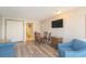 Comfortable living room includes dining area with a flat screen TV and wood flooring at 1501 S Ocean Blvd. S # 1450, Myrtle Beach, SC 29577