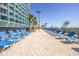 Relaxing poolside area with lounge chairs, palm trees, and ocean views under a bright blue sky at 1501 S Ocean Blvd. S # 1450, Myrtle Beach, SC 29577