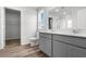 Bathroom boasts double sinks, wood-look flooring, modern fixtures, and a glass-enclosed shower at 1508 Clubstone Dr., Conway, SC 29526