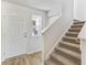 Welcoming entryway featuring a staircase, wood-look flooring, and a view to an exterior window at 1508 Clubstone Dr., Conway, SC 29526