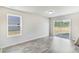 Bright living room featuring wood-look flooring, natural light, and patio door access to the backyard at 1508 Clubstone Dr., Conway, SC 29526