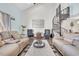 Spacious living room with spiral staircase, comfy sofas, and large artwork at 1870 Auburn Ln. # 21J, Surfside Beach, SC 29575