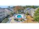 Aerial view of community pool, surrounding buildings, and landscaping at 1870 Auburn Ln. # 21J, Surfside Beach, SC 29575