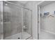 Modern shower with glass doors, a built-in seat, and a view into the walk-in closet at 1912 Seachase Way, North Myrtle Beach, SC 29582