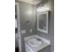 Modern bathroom features a new vanity, light fixture, and a decorative framed mirror at 206 W Pine St., Johnsonville, SC 29555