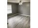 Neutrally painted bedroom featuring a ceiling fan, a window, and updated light gray flooring at 206 W Pine St., Johnsonville, SC 29555