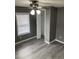 Clean bedroom with gray walls, wood-look flooring, a window, and an open closet at 206 W Pine St., Johnsonville, SC 29555