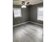 Spacious bedroom featuring a ceiling fan, two windows, and light gray vinyl floors at 206 W Pine St., Johnsonville, SC 29555