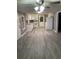 The kitchen has stainless steel appliances, white cabinetry, and gray vinyl floors at 206 W Pine St., Johnsonville, SC 29555