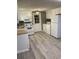 This charming kitchen is equipped with white appliances and cabinets, and gray vinyl floors at 206 W Pine St., Johnsonville, SC 29555