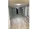 Spacious, open-concept living area boasts gray-toned walls, a ceiling fan, and updated vinyl flooring at 206 W Pine St., Johnsonville, SC 29555