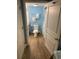 Bathroom with blue walls, wood-look floors, and white fixtures at 2701 S. Ocean B S Ocean Blvd. # 508, North Myrtle Beach, SC 29582