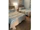 Comfortable bedroom featuring two beds with ocean-themed bedding and coordinating beach decor at 2701 S. Ocean B S Ocean Blvd. # 508, North Myrtle Beach, SC 29582