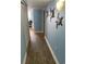 Inviting hallway features wood-look flooring and stylish turtle wall decor leading into the condo at 2701 S. Ocean B S Ocean Blvd. # 508, North Myrtle Beach, SC 29582