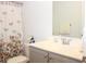 Charming bathroom with gray vanity, shower/tub combo, and floral shower curtain at 3528 Bells Lake Circle # 3528, Longs, SC 29568