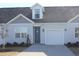 Gray siding two-story home with blue door and attached garage at 3528 Bells Lake Circle # 3528, Longs, SC 29568