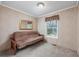 Small bedroom with a futon and large window at 3790 Woodridge Circle, Little River, SC 29566