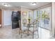 Small dining area with glass table and chairs, near sliding doors at 3790 Woodridge Circle, Little River, SC 29566