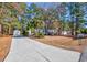 Mobile home with a long driveway and surrounding trees at 3790 Woodridge Circle, Little River, SC 29566