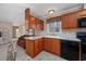 View of kitchen with stainless steel appliances and wood cabinets at 3790 Woodridge Circle, Little River, SC 29566