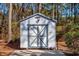 White storage shed with gray accents offers extra storage at 3790 Woodridge Circle, Little River, SC 29566