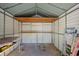 Interior of a metal storage shed with shelving and loft at 3790 Woodridge Circle, Little River, SC 29566