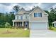Charming two-story home featuring stone accents, a two-car garage, and a well-manicured lawn at 400 Clear Lake Dr., Conway, SC 29526