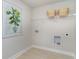 Laundry room with a hanging rack, white shelving, and tile floors at 400 Clear Lake Dr., Conway, SC 29526