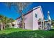 An angle view captures a charming two-story home with a lovely yard and private lift at 403 20Th Ave. N, North Myrtle Beach, SC 29582