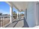 Spacious balcony with gray decking, white columns, and black railings at 434 Stanley Dr., Murrells Inlet, SC 29576