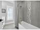 Clean bathroom with a tub shower and grey hexagonal tile feature wall at 434 Stanley Dr., Murrells Inlet, SC 29576