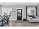 Interior entryway with black door, hardwood floors, and views into the living and dining areas at 434 Stanley Dr., Murrells Inlet, SC 29576
