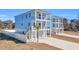 Two-story light blue houses with balconies, white fences, and palm trees at 434 Stanley Dr., Murrells Inlet, SC 29576