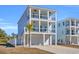 Two-story light blue house with white trim, two-car garage, and a palm tree in the front at 434 Stanley Dr., Murrells Inlet, SC 29576