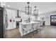 Modern white kitchen with island, stainless steel appliances, and hardwood floors at 434 Stanley Dr., Murrells Inlet, SC 29576
