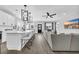 Modern white kitchen with an island, stainless steel appliances, and a large TV at 434 Stanley Dr., Murrells Inlet, SC 29576