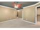 A spacious carpeted bedroom featuring a unique ceiling fan and an inviting ensuite at 4440 Lady Banks Ln. # 10H, Murrells Inlet, SC 29576