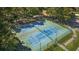 Aerial view of tennis courts surrounded by trees and parking lot nearby at 4440 Lady Banks Ln. # 10H, Murrells Inlet, SC 29576