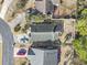 Overhead shot of the home and surrounding lot, featuring a paved driveway, fenced yard, and mature trees at 461 Spauldingwood Rd., Little River, SC 29566