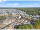 Drone shot displaying community, with a serene lake and tree-lined streets, creating a picturesque neighborhood at 461 Spauldingwood Rd., Little River, SC 29566