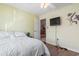 Bright bedroom with hardwood floors, a ceiling fan, and a mounted television at 461 Spauldingwood Rd., Little River, SC 29566