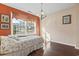 Comfortable bedroom with hardwood floors and a large window providing lots of natural light at 461 Spauldingwood Rd., Little River, SC 29566