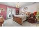 Spacious bedroom with French doors, soft carpet, and a decorative tree at 461 Spauldingwood Rd., Little River, SC 29566