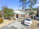 Charming brick home with well-manicured lawn, mature trees, and a spacious driveway, creating curb appeal at 461 Spauldingwood Rd., Little River, SC 29566