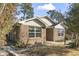 Charming brick home with manicured landscaping and mature trees on a sunny day at 461 Spauldingwood Rd., Little River, SC 29566