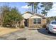 Traditional brick home with a well-kept lawn, complemented by a spacious driveway and manicured landscaping at 461 Spauldingwood Rd., Little River, SC 29566