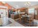 Bright eat-in kitchen features wood cabinets, stainless appliances, large kitchen island, and modern lighting at 461 Spauldingwood Rd., Little River, SC 29566